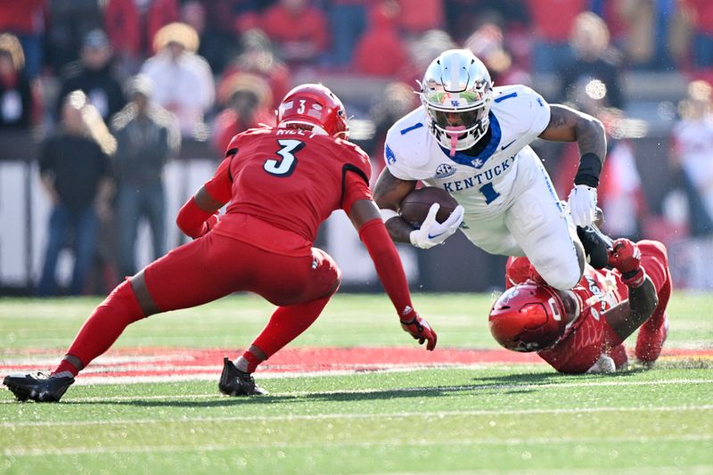 Nov 25, 2023; Louisville, Kentucky, USA;  Kentucky Wildcats running back Ray Davis (1) dives for more yardage against Louisville Cardinals defensive back Quincy Riley (3) and linebacker Jaylin Alderman (24) during the second half at L&N Federal Credit Union Stadium. Kentucky defeated Louisville 38-31. Mandatory Credit: Jamie Rhodes-USA TODAY Sports