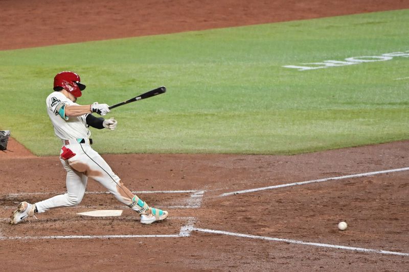 Apr 17, 2024; Phoenix, Arizona, USA;  Arizona Diamondbacks outfielder Corbin Carroll (7) singles in the fifth inning against the Chicago Cubs at Chase Field. Mandatory Credit: Matt Kartozian-USA TODAY Sports