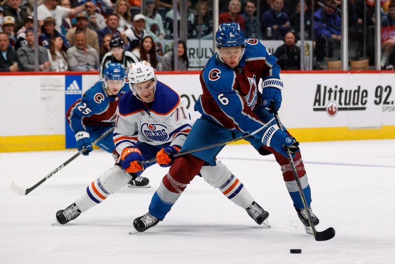 Apr 11, 2023; Denver, Colorado, USA; Colorado Avalanche defenseman Erik Johnson (6) controls the puck ahead of Edmonton Oilers center Ryan McLeod (71) in the second period at Ball Arena. Mandatory Credit: Isaiah J. Downing-USA TODAY Sports