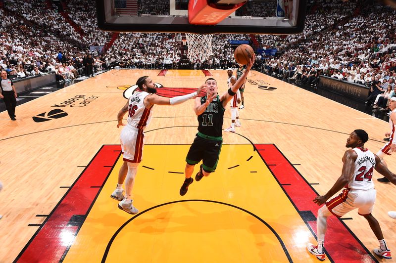 MIAMI, FL - APRIL 27: Payton Pritchard #11 of the Boston Celtics drives to the basket during the game against the Miami Heat during Round 1 Game 3 of the 2024 NBA Playoffs on April 27, 2024 at Kaseya Center in Miami, Florida. NOTE TO USER: User expressly acknowledges and agrees that, by downloading and or using this Photograph, user is consenting to the terms and conditions of the Getty Images License Agreement. Mandatory Copyright Notice: Copyright 2024 NBAE (Photo by Brian Babineau/NBAE via Getty Images)