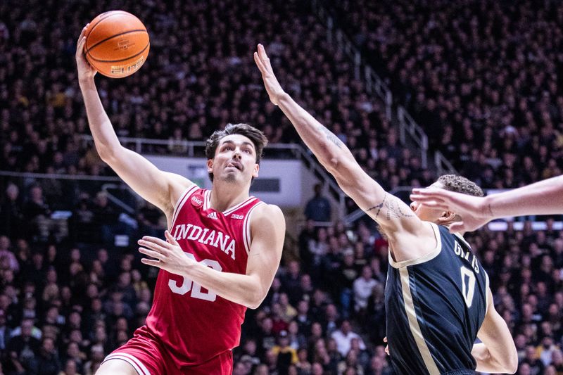 Feb 10, 2024; West Lafayette, Indiana, USA; Indiana Hoosiers guard Trey Galloway (32) shoots the ball while Purdue Boilermakers forward Mason Gillis (0) defends in the first half at Mackey Arena. Mandatory Credit: Trevor Ruszkowski-USA TODAY Sports