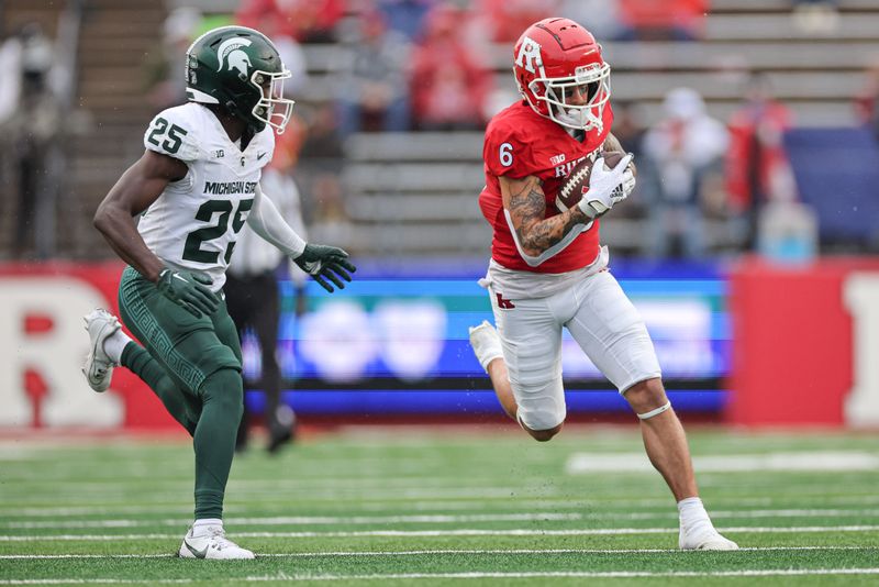 Oct 14, 2023; Piscataway, New Jersey, USA; Michigan State Spartans tight end Maliq Carr (6) carries the ball as Michigan State Spartans defensive back Chance Rucker (25) pursues during the first half at SHI Stadium. Mandatory Credit: Vincent Carchietta-USA TODAY Sports