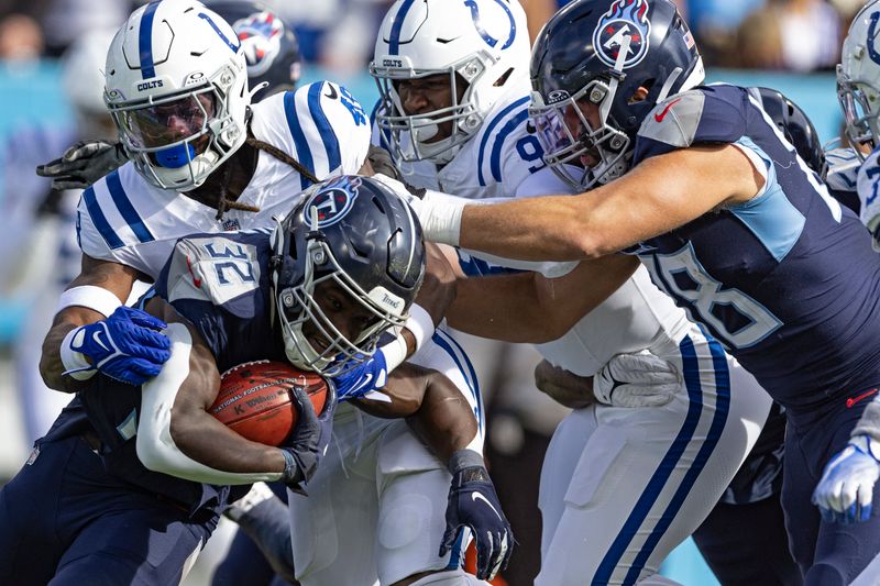 Tennessee Titans running back Tyjae Spears (32) runs for yardage as he's tackled by Indianapolis Colts safety Brandon Wilson (49) during the first half of their NFL football game Sunday, Dec. 3, 2023, in Nashville, Tenn. (AP Photo/Wade Payne)