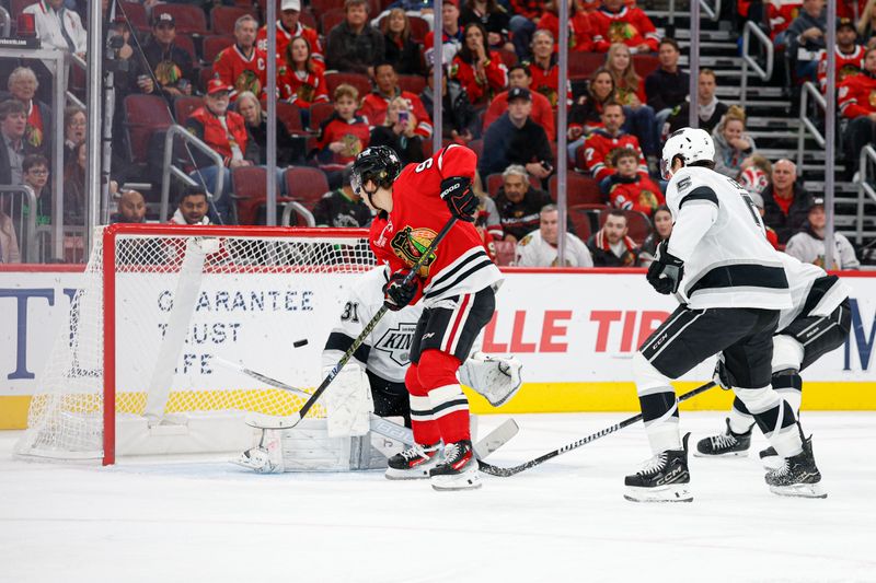 Oct 26, 2025; Chicago, Illinois, USA; Chicago Blackhawks center Connor Bedard (98) scores against Los Angeles Kings goaltender Anton Forsberg (31) during the first period at United Center. Mandatory Credit: Kamil Krzaczynski-Imagn Images