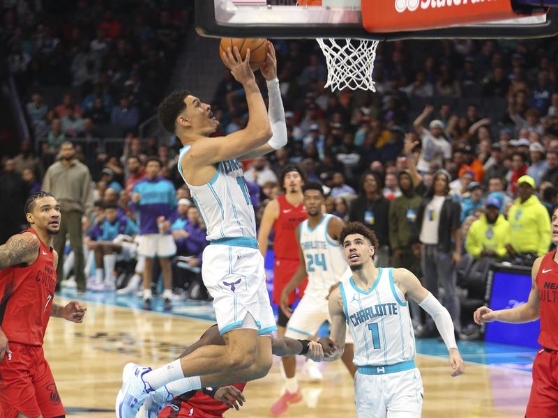 CHARLOTTE, NC - NOVEMBER 27:  Josh Green #10 of the Charlotte Hornets shoots the ball during the game against the Miami Heat on November 27, 2024 at Spectrum Center in Charlotte, North Carolina. NOTE TO USER: User expressly acknowledges and agrees that, by downloading and or using this photograph, User is consenting to the terms and conditions of the Getty Images License Agreement. Mandatory Copyright Notice: Copyright 2024 NBAE (Photo by Kent Smith/NBAE via Getty Images)