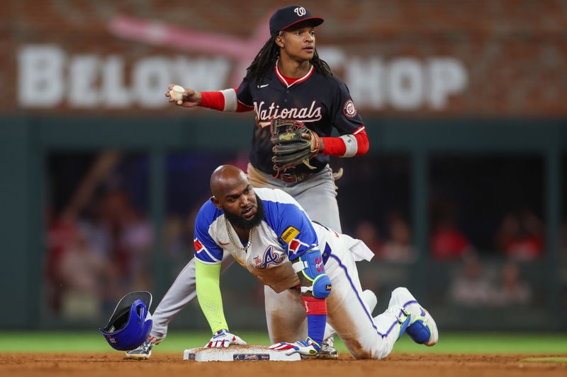 Aug 24, 2024; Atlanta, Georgia, USA; Atlanta Braves designated hitter Marcell Ozuna (20) reacts after being tagged out by Washington Nationals shortstop CJ Abrams (5) in the sixth inning at Truist Park. Mandatory Credit: Brett Davis-USA TODAY Sports