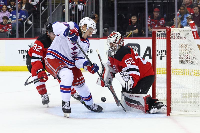 Sep 30, 2024; Newark, New Jersey, USA; New Jersey Devils goaltender Jeremy Brodeur (60) makes a save on New York Rangers left wing Adam Sykora (38) during the first period at Prudential Center. Mandatory Credit: Ed Mulholland-Imagn Images