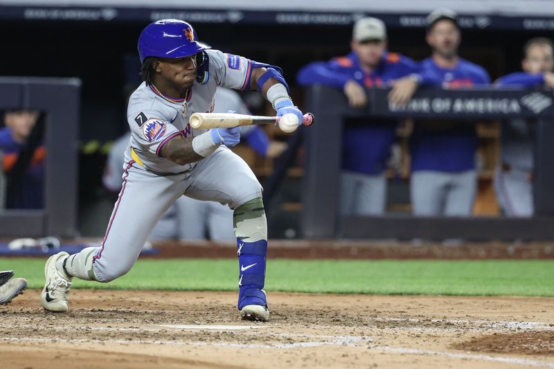 May 18, 2025; Bronx, New York, USA;  New York Mets second baseman Luisangel Acuña (2) drops down a bunt in the fifth inning against the New York Yankees at Yankee Stadium. Mandatory Credit: Wendell Cruz-Imagn Images