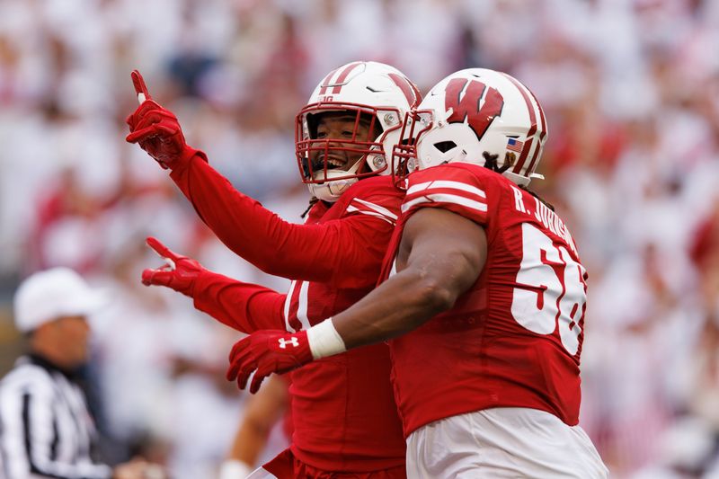 Oct 14, 2023; Madison, Wisconsin, USA;  Wisconsin Badgers linebacker Darryl Peterson (17) celebrates with defensive end Rodas Johnson (56) following a play during the second quarter against the Iowa Hawkeyes at Camp Randall Stadium. Mandatory Credit: Jeff Hanisch-USA TODAY Sports