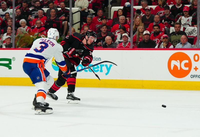 Apr 30, 2024; Raleigh, North Carolina, USA; Carolina Hurricanes right wing Andrei Svechnikov (37) takes a shot against the New York Islanders during the first period in game five of the first round of the 2024 Stanley Cup Playoffs at PNC Arena. Mandatory Credit: James Guillory-USA TODAY Sports