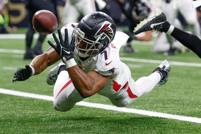 Atlanta Falcons running back Bijan Robinson (7) bobbles the ball in the second half of an NFL football game against the New Orleans Saints in New Orleans, Sunday, Jan. 7, 2024. (AP Photo/Butch Dill)