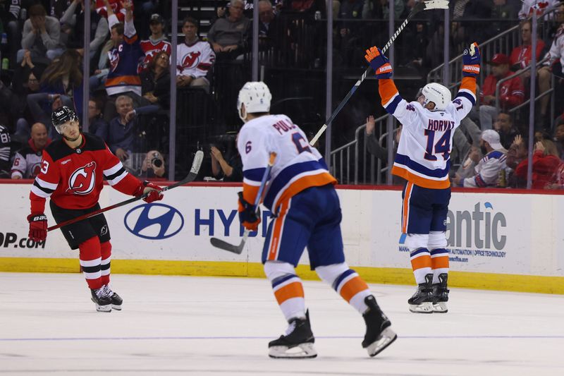 Oct 25, 2024; Newark, New Jersey, USA; New York Islanders center Bo Horvat (14) celebrates his game winning goal against the New Jersey Devils in overtime at Prudential Center. Mandatory Credit: Ed Mulholland-Imagn Images