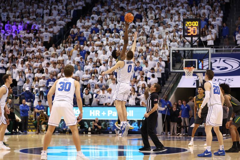 Feb 20, 2024; Provo, Utah, USA; Baylor Bears center Yves Missi (21) and Brigham Young Cougars forward Noah Waterman (0) jump the ball to start the game at Marriott Center. Mandatory Credit: Rob Gray-USA TODAY Sports