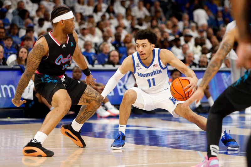 Feb 25, 2024; Memphis, Tennessee, USA; Memphis Tigers guard Jahvon Quinerly (11) dribbles as Florida Atlantic Owls guard Alijah Martin (15) defends during the first half at FedExForum. Mandatory Credit: Petre Thomas-USA TODAY Sports