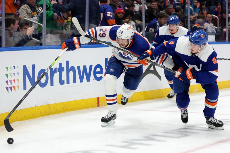 Dec 19, 2023; Elmont, New York, USA; Edmonton Oilers center Leon Draisaitl (29) fights for the puck against New York Islanders defenseman Noah Dobson (8) during the third period at UBS Arena. Mandatory Credit: Brad Penner-USA TODAY Sports