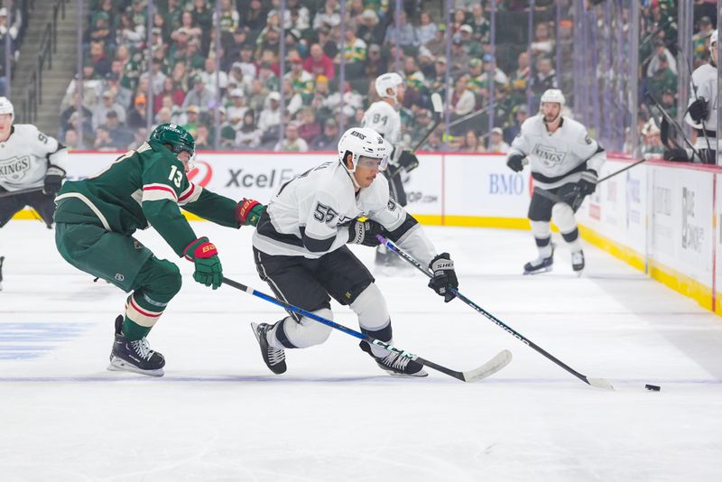 Nov 5, 2024; Saint Paul, Minnesota, USA; Los Angeles Kings right wing Quinton Byfield (55) skates with the puck against the Minnesota Wild center Yakov Trenin (13) in the first period at Xcel Energy Center. Mandatory Credit: Brad Rempel-Imagn Images