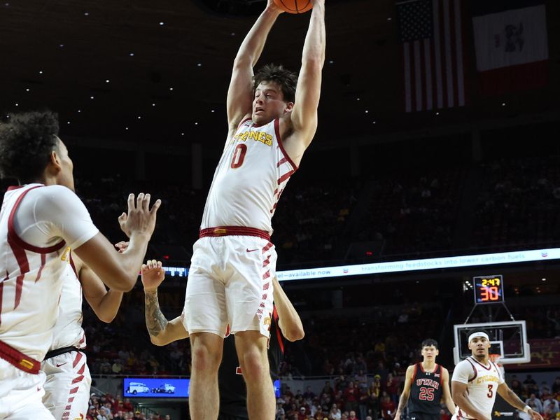 Jan 7, 2025; Ames, Iowa, USA; Utah Utes guard Hunter Erickson (0) grabs a rebound against the Utah Utes in the  second half at James H. Hilton Coliseum. Mandatory Credit: Reese Strickland-Imagn Images