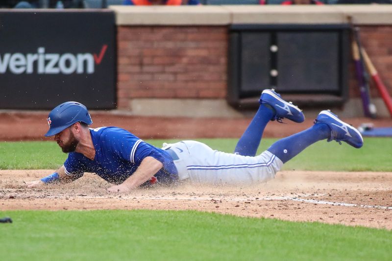 Jun 3, 2023; New York City, New York, USA;  Toronto Blue Jays designated hitter Brandon Belt (13) slides safely to score the tying run in the sixth inning against the New York Mets at Citi Field. Mandatory Credit: Wendell Cruz-USA TODAY Sports