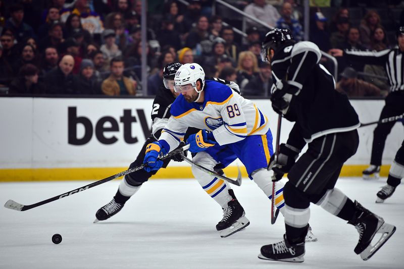 Feb 13, 2023; Los Angeles, California, USA; Buffalo Sabres right wing Alex Tuch (89) moves the puck against Los Angeles Kings defenseman Alexander Edler (2) and defenseman Drew Doughty (8) during the first period at Crypto.com Arena. Mandatory Credit: Gary A. Vasquez-USA TODAY Sports