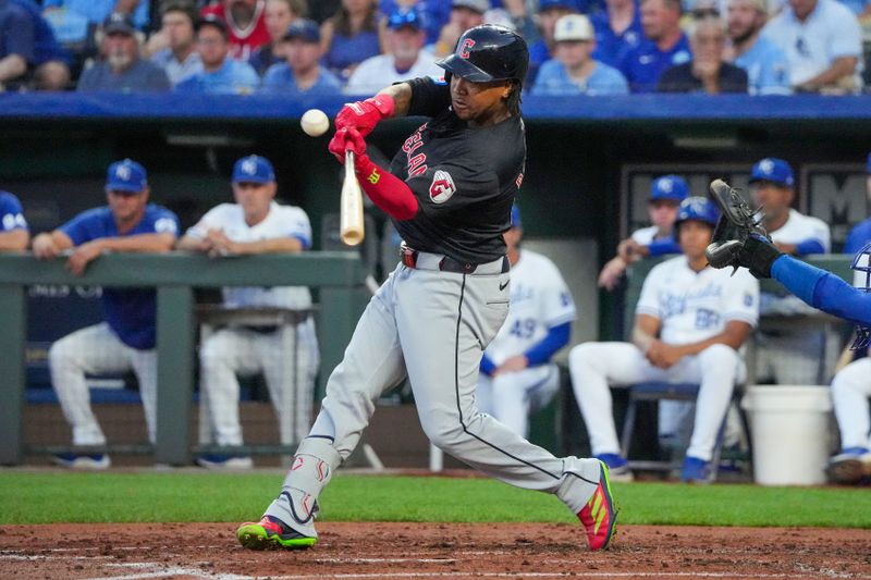 Sep 4, 2024; Kansas City, Missouri, USA; Cleveland Guardians third baseman José Ramírez (11) hits a one run single against the Kansas City Royals in the third inning at Kauffman Stadium. Mandatory Credit: Denny Medley-Imagn Images