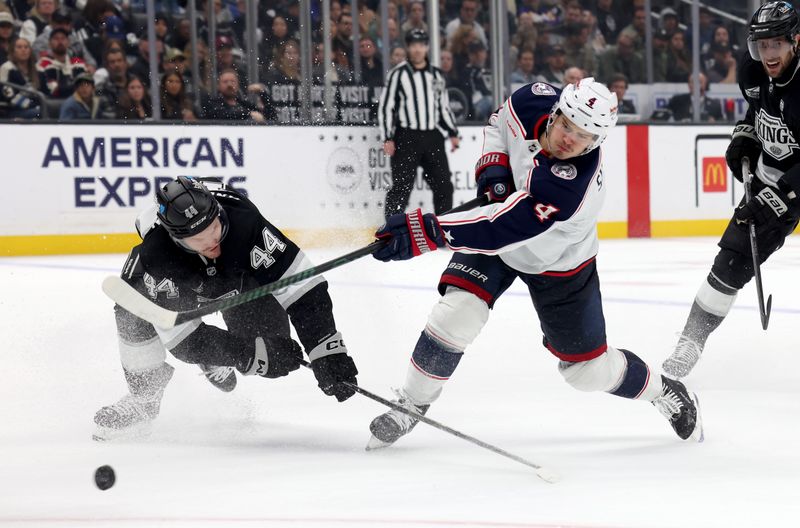 Nov 9, 2024; Los Angeles, California, USA; Columbus Blue Jackets center Cole Sillinger (4) shoots against Los Angeles Kings defenseman Mikey Anderson (44) during the third period at Crypto.com Arena. Mandatory Credit: Jason Parkhurst-Imagn Images