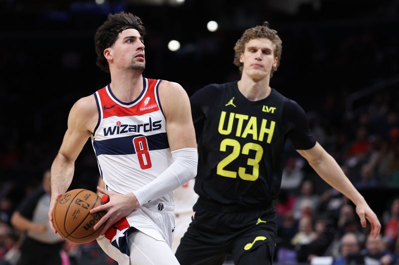 WASHINGTON, DC - JANUARY 25: Deni Avdija #8 of the Washington Wizards drives to the basket in front of Lauri Markkanen #23 of the Utah Jazz during the first half at Capital One Arena on January 25, 2024 in Washington, DC. NOTE TO USER: User expressly acknowledges and agrees that, by downloading and or using this photograph, User is consenting to the terms and conditions of the Getty Images License Agreement. (Photo by Patrick Smith/Getty Images)