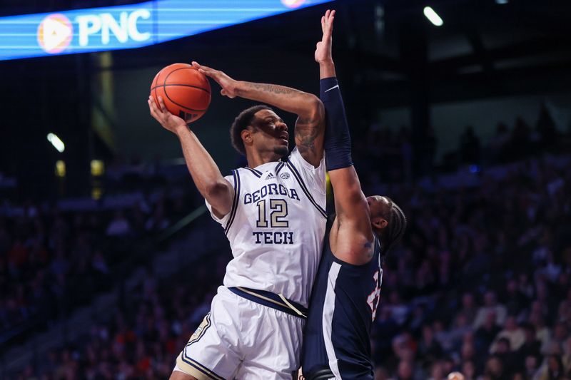 Jan 20, 2024; Atlanta, Georgia, USA; Georgia Tech Yellow Jackets forward Tyzhaun Claude (12) shoots over Virginia Cavaliers forward Jordan Minor (22) in the second half at McCamish Pavilion. Mandatory Credit: Brett Davis-USA TODAY Sports
