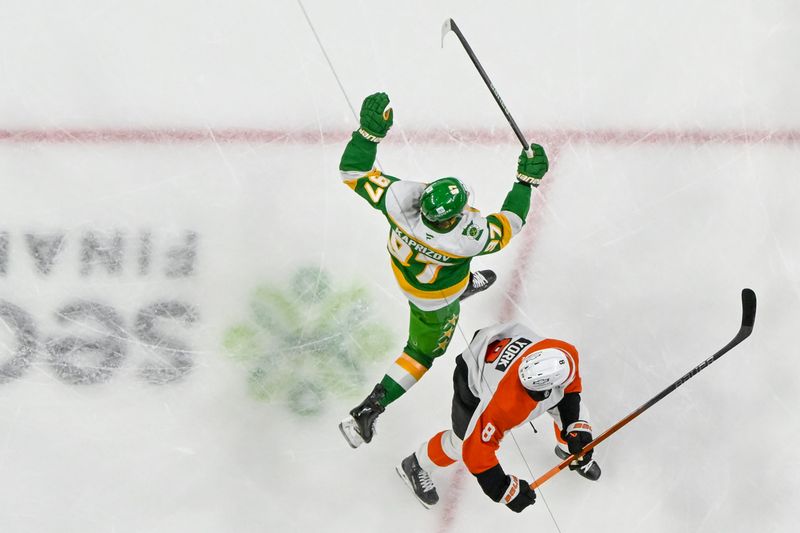 Dec 14, 2024; Saint Paul, Minnesota, USA;  Minnesota Wild forward Kirill Kaprizov (97) celebrates while jumping around Philadelphia Flyers defenseman Cam York (8) after scoring a goal during the first period at Xcel Energy Center. Mandatory Credit: Nick Wosika-Imagn Images