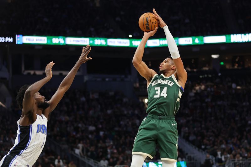 MILWAUKEE, WISCONSIN - DECEMBER 21: Giannis Antetokounmpo #34 of the Milwaukee Bucks shoots over Jonathan Isaac #1 of the Orlando Magic during a game at Fiserv Forum on December 21, 2023 in Milwaukee, Wisconsin. NOTE TO USER: User expressly acknowledges and agrees that, by downloading and or using this photograph, User is consenting to the terms and conditions of the Getty Images License Agreement. (Photo by Stacy Revere/Getty Images)