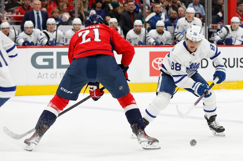 Nov 13, 2024; Washington, District of Columbia, USA; Toronto Maple Leafs right wing William Nylander (88) skates with the puck as Washington Capitals center Aliaksei Protas (21) defends in the second period at Capital One Arena. Mandatory Credit: Geoff Burke-Imagn Images