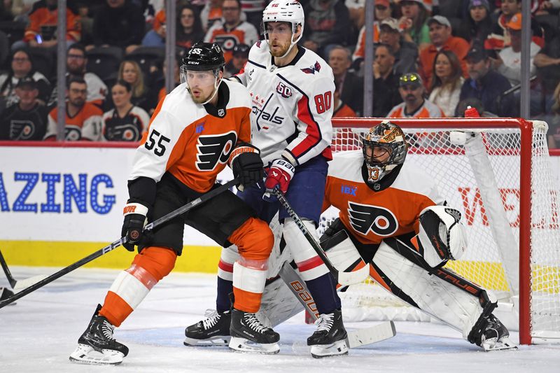 Oct 22, 2024; Philadelphia, Pennsylvania, USA; Philadelphia Flyers defenseman Rasmus Ristolainen (55) and Washington Capitals left wing Pierre-Luc Dubois (80) battle for position in front of goaltender Samuel Ersson (33) during the first period at Wells Fargo Center. Mandatory Credit: Eric Hartline-Imagn Images