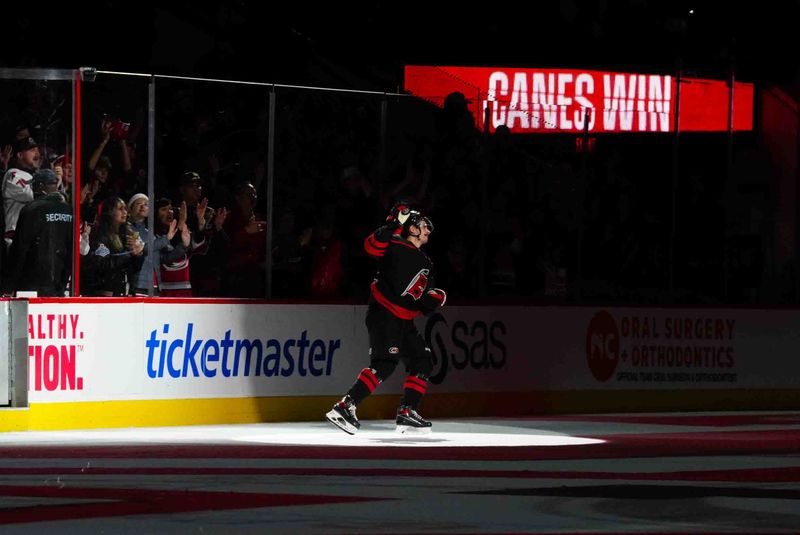 Nov 22, 2023; Raleigh, North Carolina, USA; Carolina Hurricanes center Seth Jarvis (24) celebrate their victory against the Edmonton Oilers at PNC Arena. Mandatory Credit: James Guillory-USA TODAY Sports