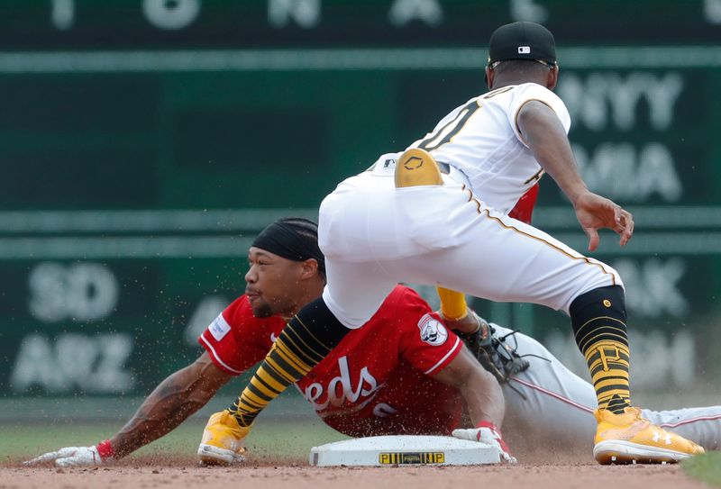 Aug 13, 2023; Pittsburgh, Pennsylvania, USA; Cincinnati Reds right fielder Will Benson (left) steals second base as Pittsburgh Pirates shortstop Liover Peguero (60) applies a late tag during the fifth inning at PNC Park. Mandatory Credit: Charles LeClaire-USA TODAY Sports