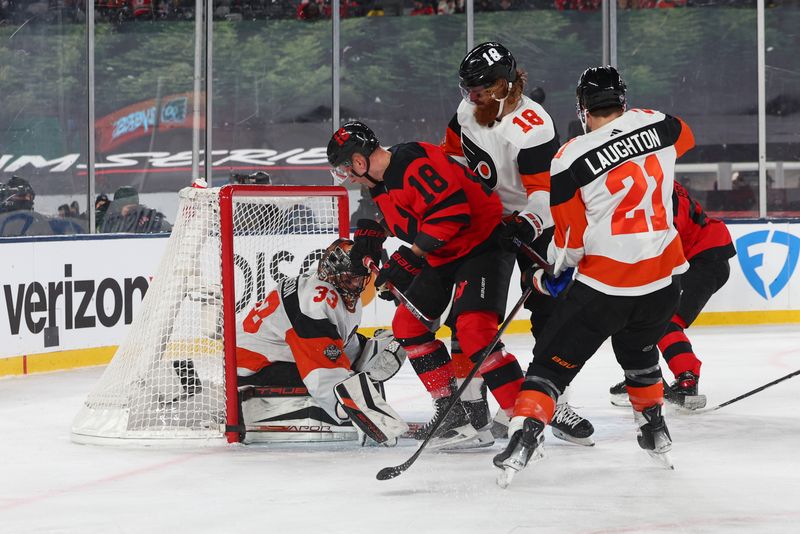 Feb 17, 2024; East Rutherford, New Jersey, USA; New Jersey Devils left wing Ondrej Palat (18) and Philadelphia Flyers defenseman Marc Staal (18) battle in front of Philadelphia Flyers goaltender Samuel Ersson (33) during the second period in a Stadium Series ice hockey game at MetLife Stadium. Mandatory Credit: Ed Mulholland-USA TODAY Sports