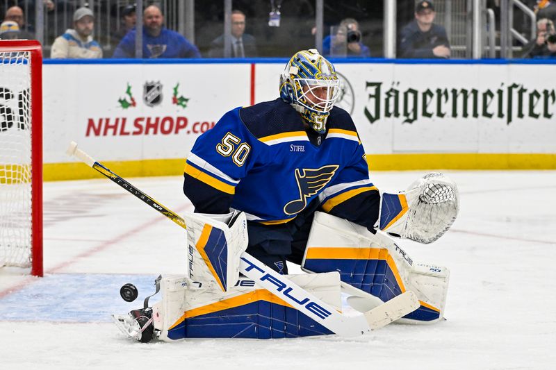 Nov 30, 2023; St. Louis, Missouri, USA;  St. Louis Blues goaltender Jordan Binnington (50) makes a save against the Buffalo Sabres during the third period at Enterprise Center. Mandatory Credit: Jeff Curry-USA TODAY Sports