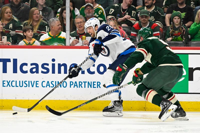 Apr 11, 2023; Saint Paul, Minnesota, USA;  Winnipeg Jets forward Kevin Stenlund (28) makes a pass as Minnesota Wild defense Jacob Middleton (5) defends during the third period at at Xcel Energy Center. Mandatory Credit: Nick Wosika-USA TODAY Sports