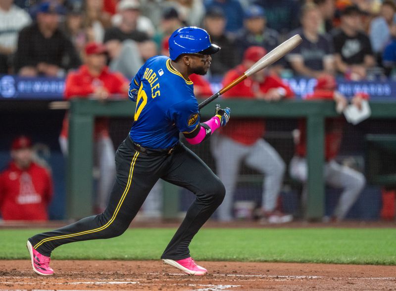 Sep 12, 2025; Seattle, Washington, USA; Seattle Mariners right fielder Victor Robles (10) hits a single during the third inning at T-Mobile Park. Mandatory Credit: Stephen Brashear-Imagn Images