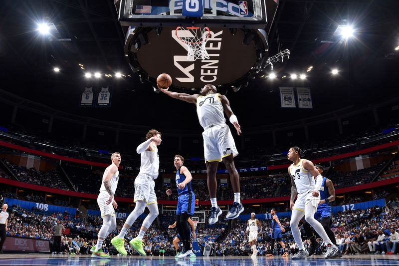 ORLANDO, FL - FEBRUARY 29: Kris Dunn #11 of the Utah Jazz rebounds the ball during the game against the Orlando Magic on February 29, 2024 at Amway Center in Orlando, Florida. NOTE TO USER: User expressly acknowledges and agrees that, by downloading and or using this photograph, User is consenting to the terms and conditions of the Getty Images License Agreement. Mandatory Copyright Notice: Copyright 2024 NBAE (Photo by Fernando Medina/NBAE via Getty Images)