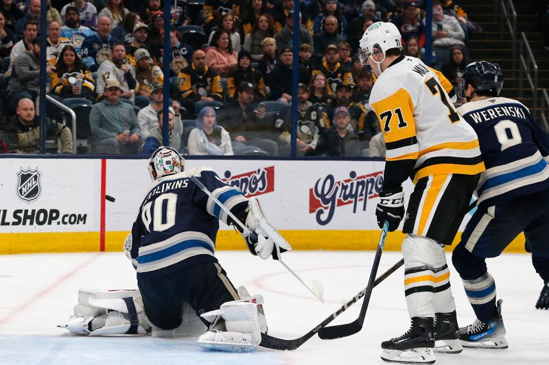 Nov 15, 2024; Columbus, Ohio, USA; Columbus Blue Jackets goalie Elvis Merzlikins (90) makes a save as Pittsburgh Penguins center Evgeni Malkin (71) looks for a rebound during the third period at Nationwide Arena. Mandatory Credit: Russell LaBounty-Imagn Images