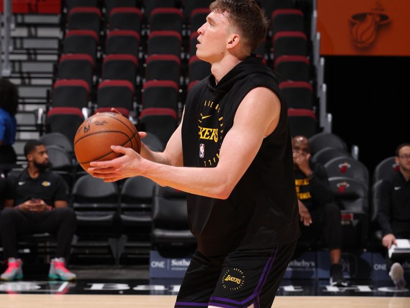 MIAMI, FL - DECEMBER 4: Dalton Knecht #4 of the Los Angeles Lakers warms up before the game against the Miami Heat on December 4, 2024 at Kaseya Center in Miami, Florida. NOTE TO USER: User expressly acknowledges and agrees that, by downloading and or using this Photograph, user is consenting to the terms and conditions of the Getty Images License Agreement. Mandatory Copyright Notice: Copyright 2024 NBAE (Photo by Joe Murphy/NBAE via Getty Images)