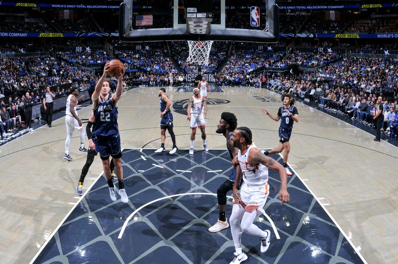 ORLANDO, FL - JANUARY 28: Franz Wagner #22 of the Orlando Magic grabs the rebound during the game on January 28, 2024 at Amway Center in Orlando, Florida. NOTE TO USER: User expressly acknowledges and agrees that, by downloading and or using this photograph, User is consenting to the terms and conditions of the Getty Images License Agreement. Mandatory Copyright Notice: Copyright 2024 NBAE (Photo by Fernando Medina/NBAE via Getty Images)