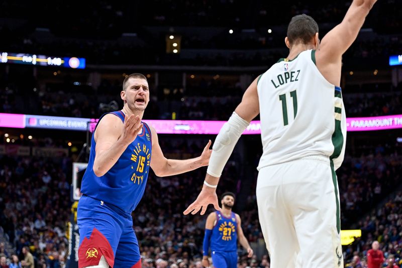 DENVER, CO - MARCH 25:  Nikola Jokic #15 of the Denver Nuggets reacts after scoring past Brook Lopez #11 of the Milwaukee Bucks in the first half of a game at Ball Arena on March 25, 2023 in Denver, Colorado. NOTE TO USER: User expressly acknowledges and agrees that, by downloading and or using this photograph, User is consenting to the terms and conditions of the Getty Images License Agreement. (Photo by Dustin Bradford/Getty Images)