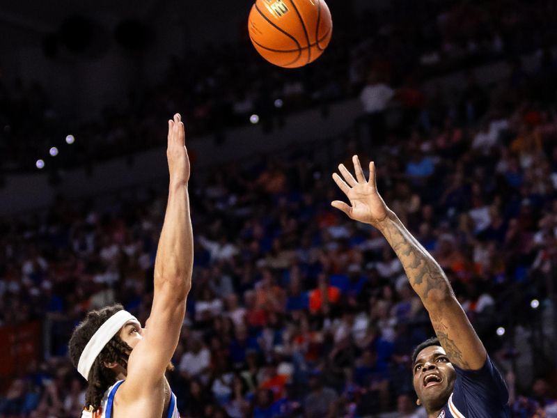 Feb 10, 2024; Gainesville, Florida, USA; Auburn Tigers guard K.D. Johnson (0) shoots the ball over Florida Gators guard Walter Clayton Jr. (1) during the first half at Exactech Arena at the Stephen C. O'Connell Center. Mandatory Credit: Matt Pendleton-USA TODAY Sports