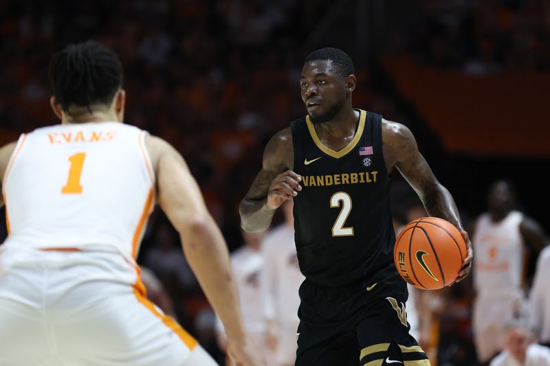 Mar 7, 2026; Knoxville, Tennessee, USA;  Vanderbilt Commodores guard Duke Miles (2) moves the ball against Tennessee Volunteers guard Amari Evans (1) during the second half at Thompson-Boling Arena at Food City Center. Mandatory Credit: Randy Sartin-Imagn Images