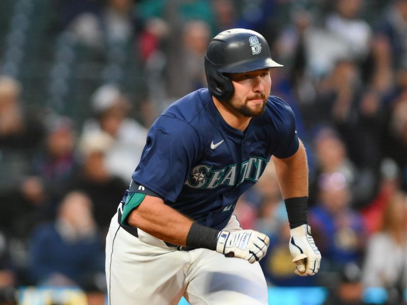 Jun 11, 2024; Seattle, Washington, USA; Seattle Mariners catcher Cal Raleigh (29) runs towards first base after hitting a 2-RBI double against the Chicago White Sox during the seventh inning at T-Mobile Park. Mandatory Credit: Steven Bisig-USA TODAY Sports