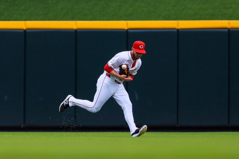 Jul 14, 2024; Cincinnati, Ohio, USA; Cincinnati Reds outfielder Austin Slater (48) attempts to catch a fly out hit by Miami Marlins shortstop Xavier Edwards (not pictured) in the sixth inning at Great American Ball Park. Mandatory Credit: Katie Stratman-USA TODAY Sports