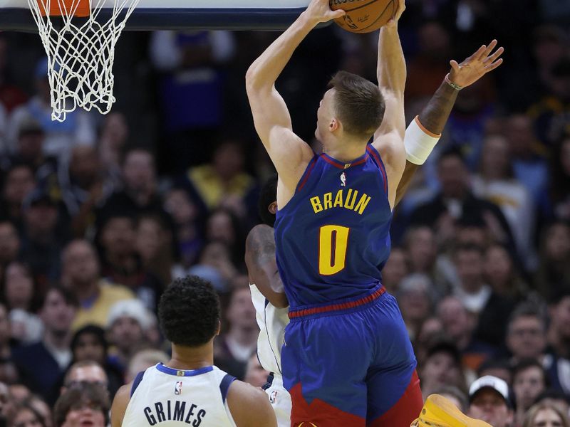 DENVER, COLORADO - NOVEMBER 22: Christian Braun #0 of the Denver Nuggets goes to the basket against Kyrie Irving #11 of the Dallas Mavericks in the first quarter of the Emirates NBA Cup at Ball Arena on November 22, 2024 in Denver, Colorado. NOTE TO USER: User expressly acknowledges and agrees that, by downloading and or using this photograph, User is consenting to the terms and conditions of the Getty Images License Agreement.  (Photo by Matthew Stockman/Getty Images)