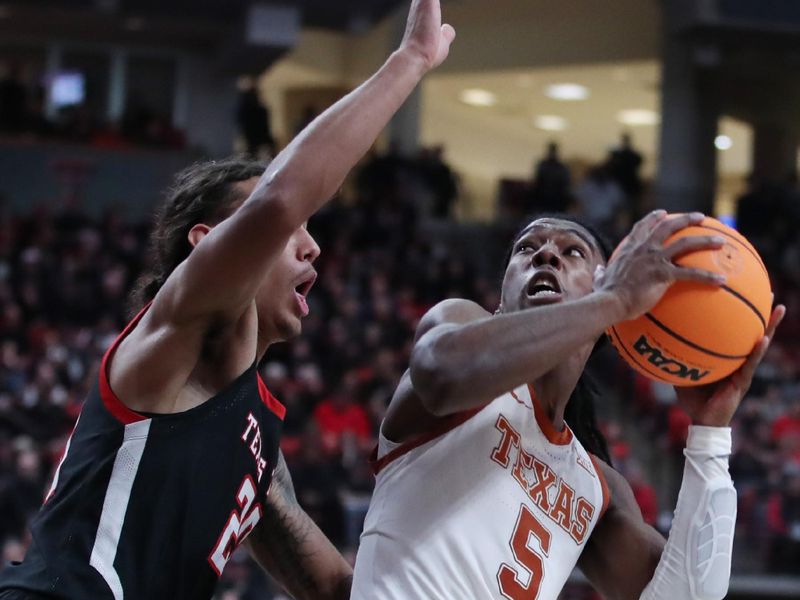 Feb 13, 2023; Lubbock, Texas, USA;  Texas Longhorns guard Marcus Carr (5) looks to shoot against Texas Tech Red Raiders guard Jaylon Tyson (20) in the second half at United Supermarkets Arena. Mandatory Credit: Michael C. Johnson-USA TODAY Sports