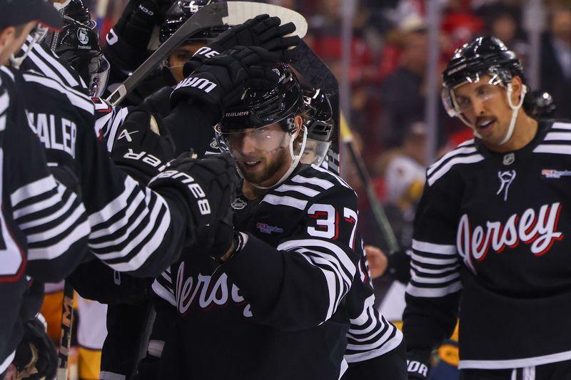 Nov 25, 2024; Newark, New Jersey, USA; New Jersey Devils center Justin Dowling (37) celebrates his empty net goal against the Nashville Predators during the third period at Prudential Center. Mandatory Credit: Ed Mulholland-Imagn Images