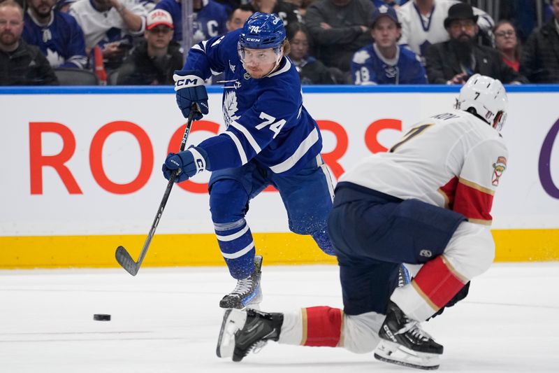May 5, 2025; Toronto, Ontario, CAN; Toronto Maple Leafs forward Bobby McMann (74) shoots against Florida Panthers defenseman Dmitry Kulikov (7) during the first period of game one of the second round of the 2025 Stanley Cup Playoffs at Scotiabank Arena. Mandatory Credit: John E. Sokolowski-Imagn Images